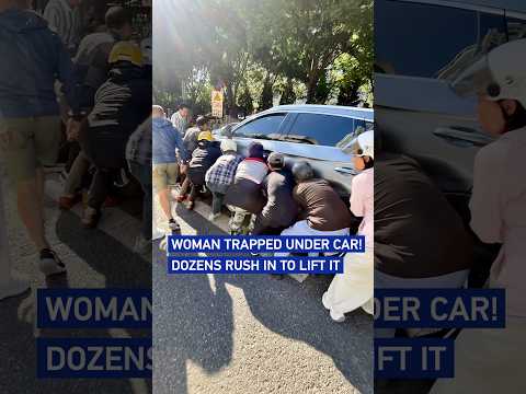 Woman trapped under car! Dozens rush in to lift it
