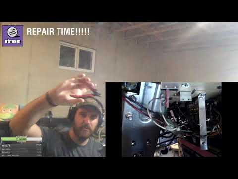 Replacing a broken rollover switch on a pinball machine.