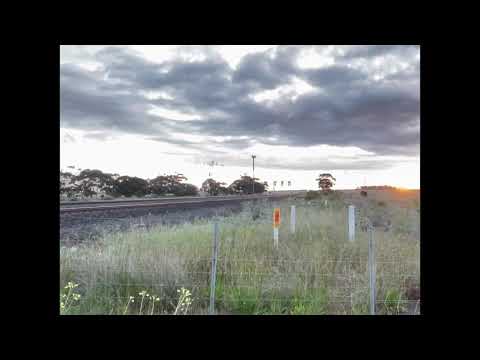 Sunset of 7MC6 crossing a down V/Line Warrnambool loco-hauled pass