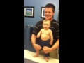 Baby adorably flexes muscles with dad 