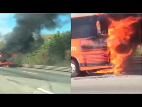Car drives past burning Bolt Bus on Massachusetts Turnpike