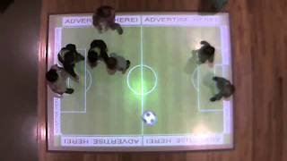 Children playing virtual soccer on an AdVis interactive projection floor system.