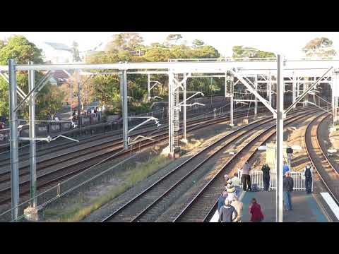 Steam and modern locomotives pass Petersham Station, Sydney, Australia.
