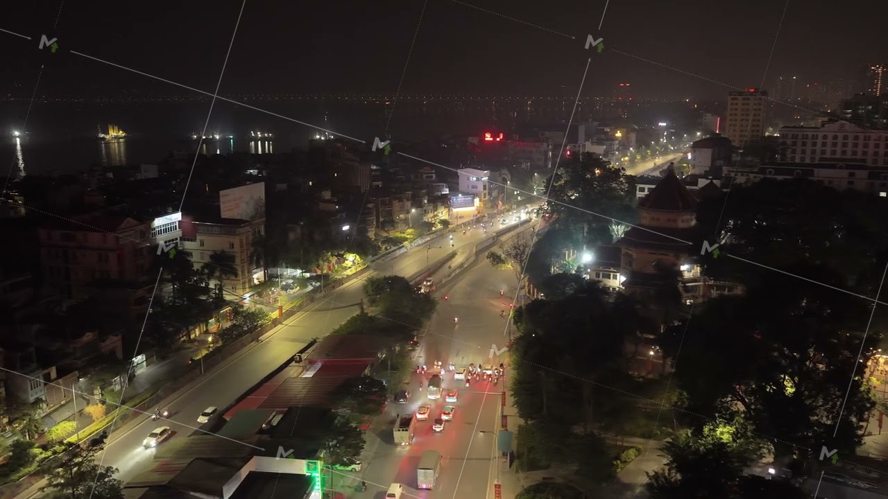 Illuminated street with intense traffic flow at night in Hanoi, Vietnam, urban development and city