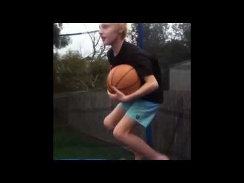 Shooting a basketball into a hoop on a trampoline