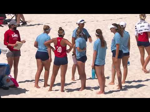 Sunbathe on the beach and watch volleyball players play