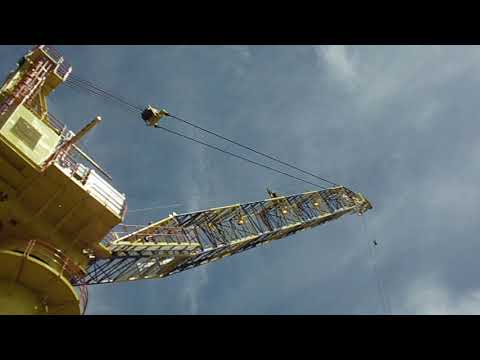 Material transfer from floating barge to production platform