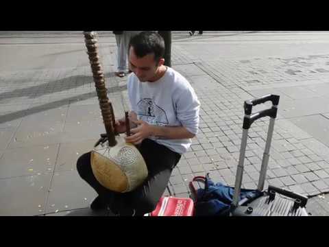 AGAIN   JOHN BUSKING IN MANCHESTER ON KORA