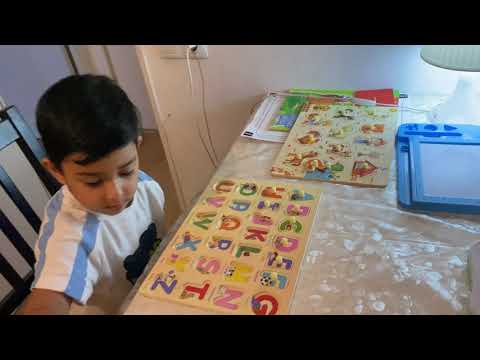 Kanav is reading alphabet and  learning animals and alphabet with blocks