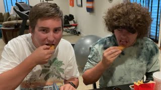two guys eating the bts meal