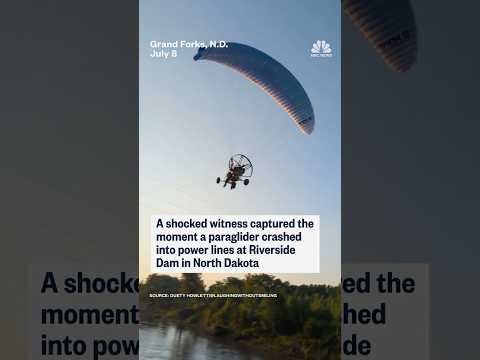 A shocked witness captured the moment a paraglider crashed into power lines in North Dakota