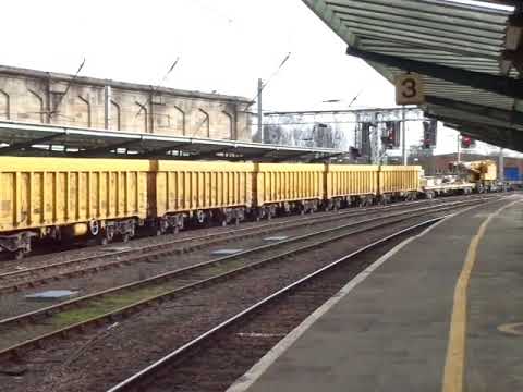 The x4 Class 66 DRS & Freightliner with Breakdown Crane & MBA Wagons is passing slowly at Carlisle!