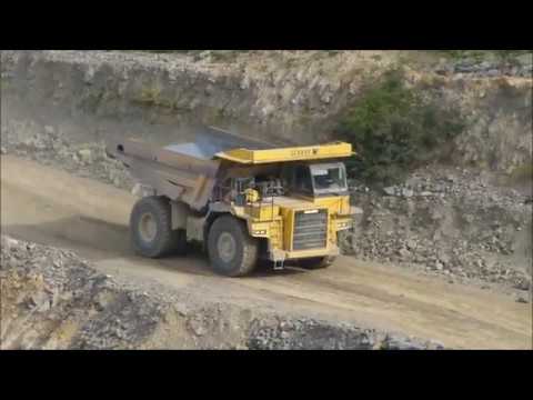 Komatsu HD605 trucks are loaded by a PC800 excavator