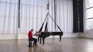 Tesla Bot's Leg Actuator Lifting a Half-Ton Piano