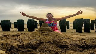 ABDL building sand castle at the beach in a diaper
