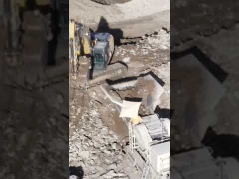 Close up look Caterpillar 352F Excavator Dumping Rocks into Metso NW150 Portable Jaw Crusher #shorts