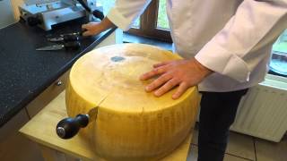 opening a wheel of parmesan cheese (parmigiano reggiano)