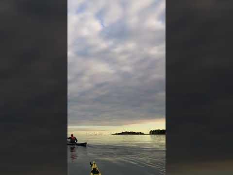 Amazing cloud cover meets horizon over flatwater - seen from sea kayak, Finnish archipelago