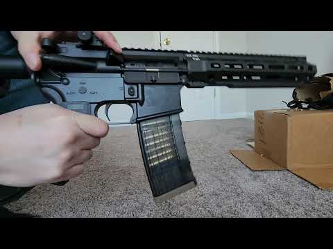 Airsoft Modified Rare Arms AR-15 With Translucent Mag and Real 5.56 Casings