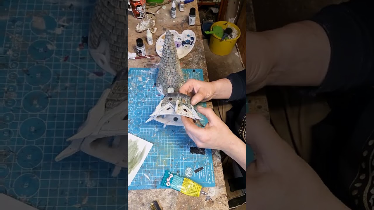 Person is putting finishing touches on an Elfin tower model!