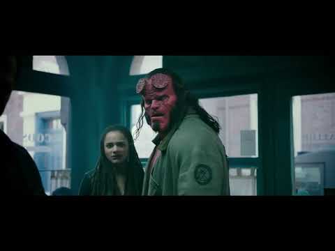 Trailer frame of Hellboy drawing Excalibur amid flames, reflecting the score’s doom-tinged motif