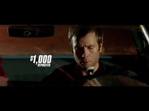 Red band trailer still: phone ringing in a dim apartment, dread building