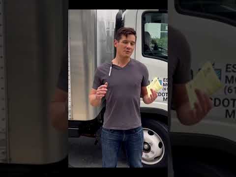 Customer sharing feedback beside an Esquire Moving truck