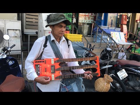 Thai Man Playing Triple Neck Guitar