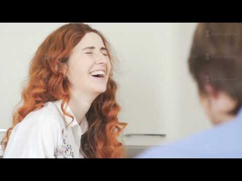 Woman with blue eyes and bright red hair communicates with her man