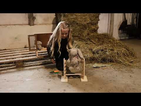 Cute plush bunny enjoys a jumping session while baby bunny watches