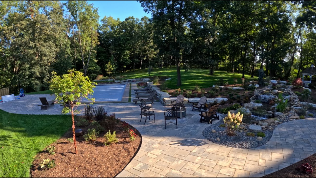 Paver Pool Deck With Turf Inlays and Pond Less Waterfall