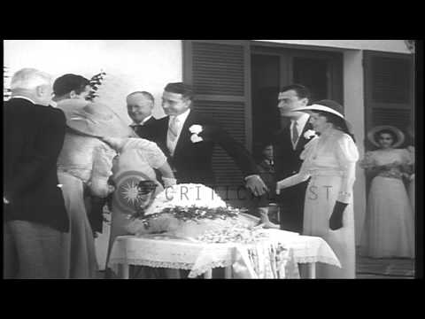 Mary Pickford and Buddy Rogers being greeted by guests after their wedding in Bel...HD Stock Footage