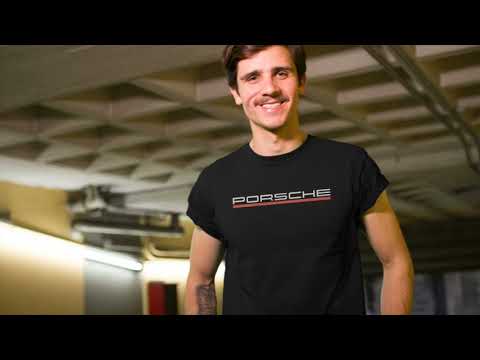 hipster guy with tattoos and a mustache walking through a city tunnel wearing a T-Shirt PORSCHE