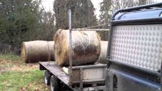 loading round bales on trailer with landrover