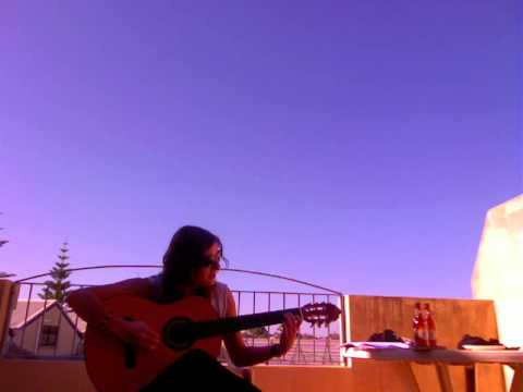 French girl singing and playing guitar on a beautiful day