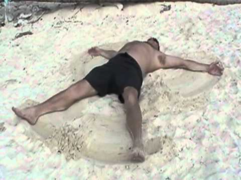 Dr Terdal makes sand angel on beach