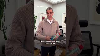 Spain's PM displays Gaza child refugee's bottled message in office