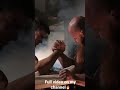 Young boy beating professional powerlifter in arm wrestling