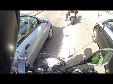 motorbiker helps silly girl with open boot Video