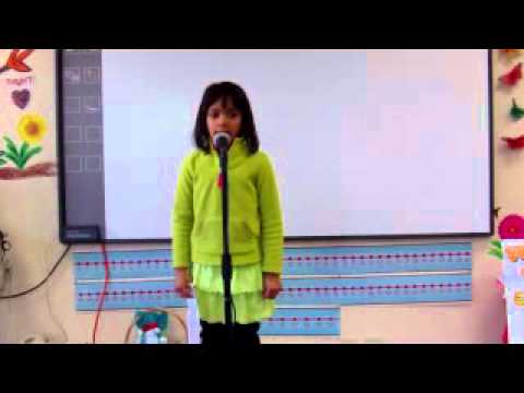 Nitya presenting dog facts on stage. The Lil' Genius Kid.