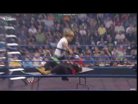 Edge splashes Mick Foley off ladder through table