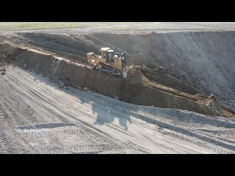 Caterpillar D9T Bulldozer Levelling Huge Old Mining Area - Drone View