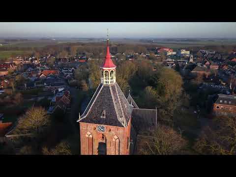 Middelstum windmill and church closeup round.