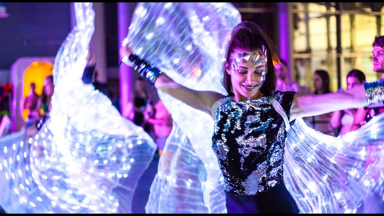 Five dancers performing an illuminated LED wings show for events in Dubai by ILLIZIUM