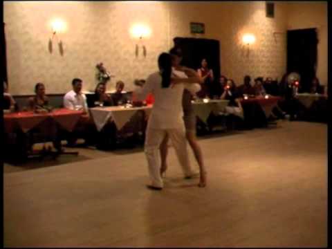  Adrian Costa  and  Amanda Costa  are  dancing  to  the  tango  "  El Olivo  "