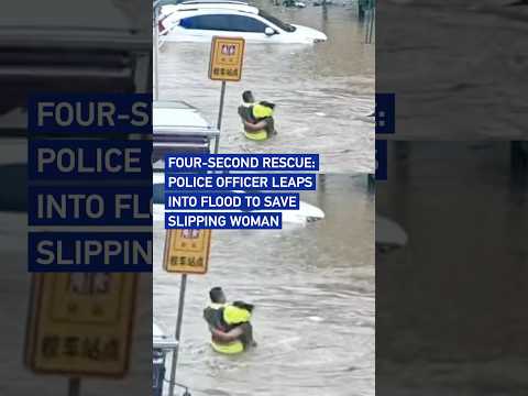 Four-second rescue: Police officer leaps into flood to save slipping woma