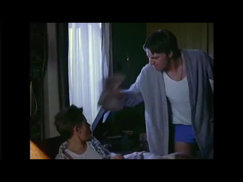 Billy Elliot official trailer frame: Billy in boxing gym glancing toward ballet class