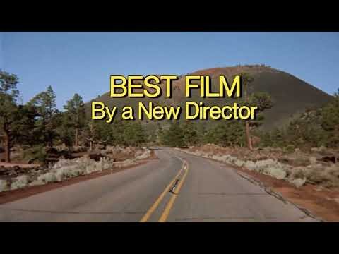 Trailer frame: nighttime New Orleans footage and neon signs dissolving toward the cemetery sequence