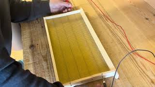 Embedding wax foundation onto wired frames