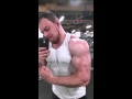 Huge ripped bodybuilder flexes in the gym